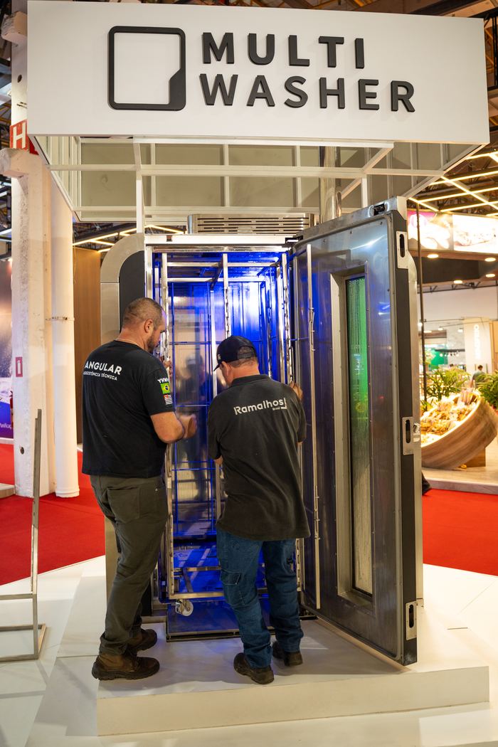Estande MultiWasher na FIPAN 2025, com a máquina aberta e o carrinho na câmara